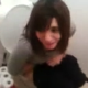 A low-quality video of a girl sitting on the toilet taking a shit.